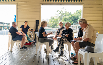 Group of people sitting in a circle in discussion